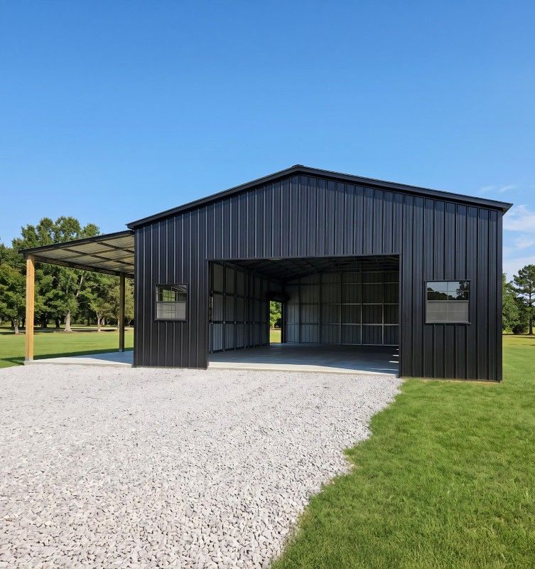 Black post frame shop with an open bay and attached lean-to