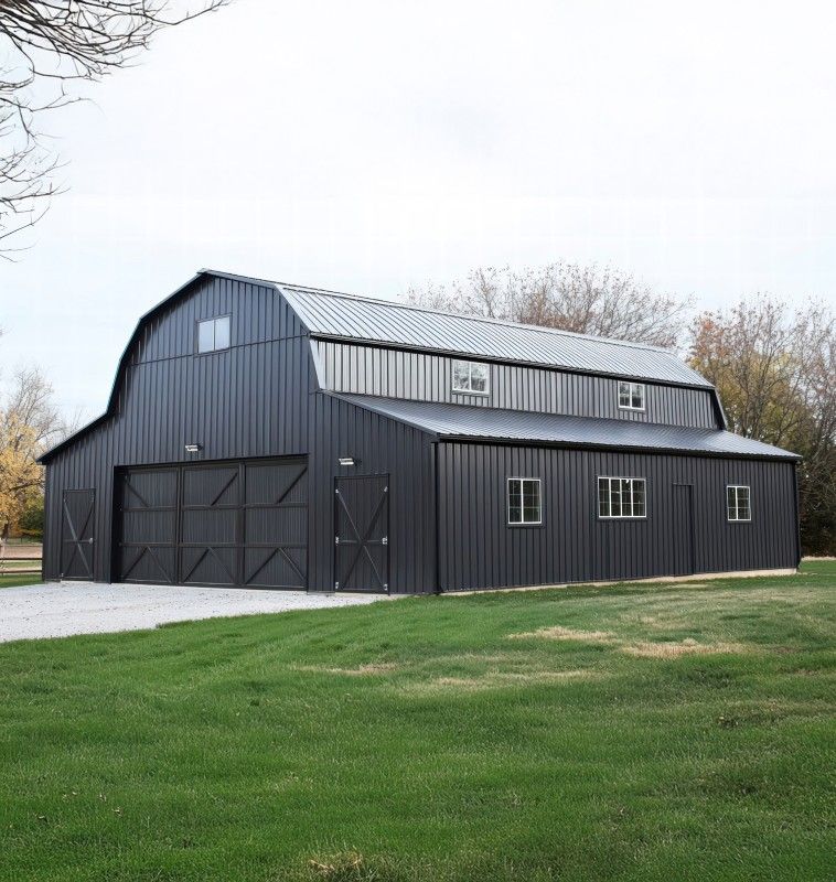 Black gambrel-roof barn with sliding doors and windows