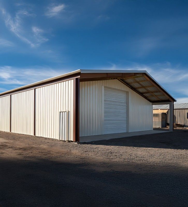 Long cream commercial post frame building with a large overhead door