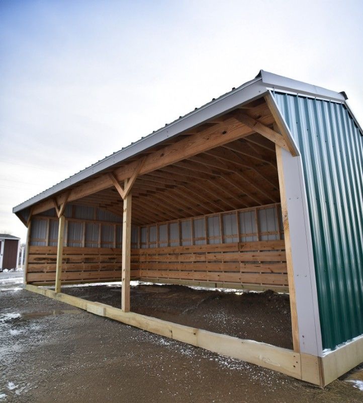 Open-sided run-in shed with timber posts and a green steel roof